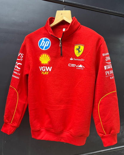 Red sweatshirt with various logos on a hanger against a black background