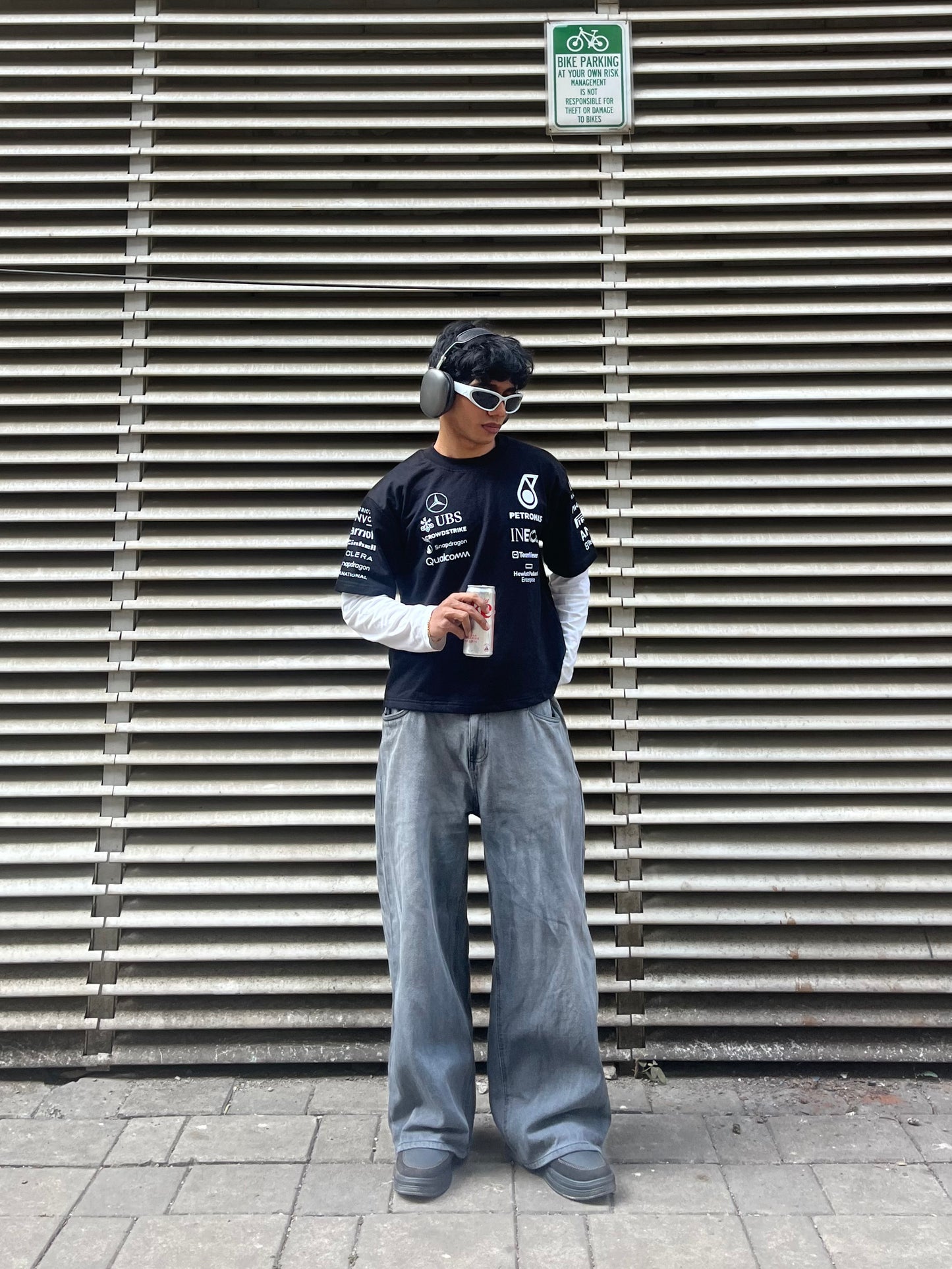 model wearing Petronas inspired black F1 racing t shirt motorsport streetwear outfit