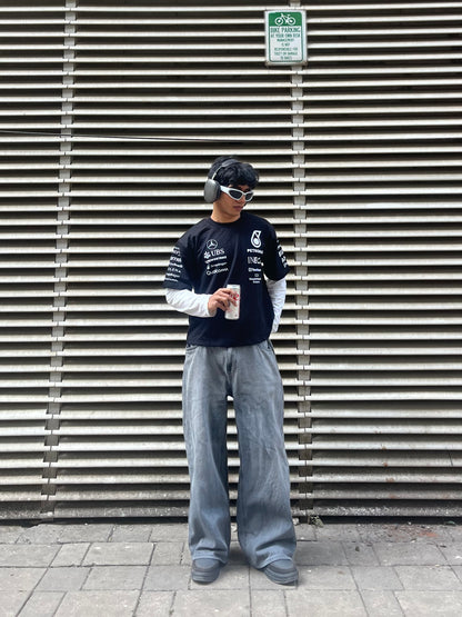 model wearing Petronas inspired black F1 racing t shirt motorsport streetwear outfit