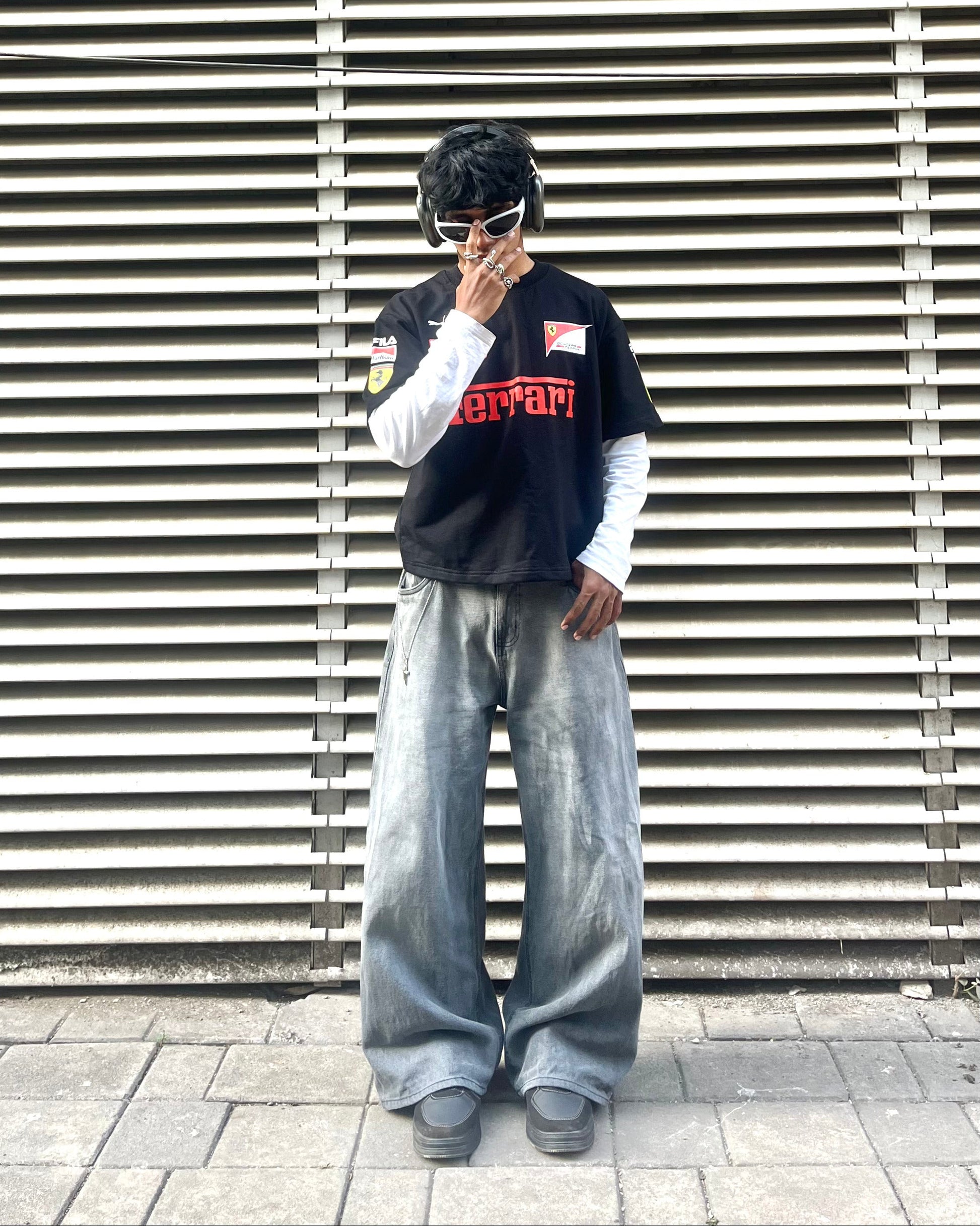 model wearing Ferrari inspired black F1 racing t shirt motorsport streetwear outfit