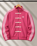 Premium pink CNY track jacket hanging on wooden hanger with white stripes.
